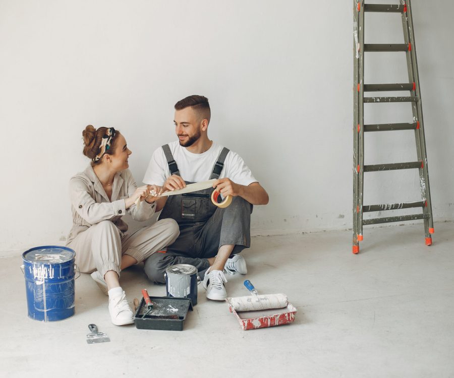 Family repairs. Couple at home. Woman in a overalls